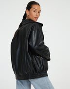 Side back view of the black oversized jacket highlighting the elasticated hem and collar shape