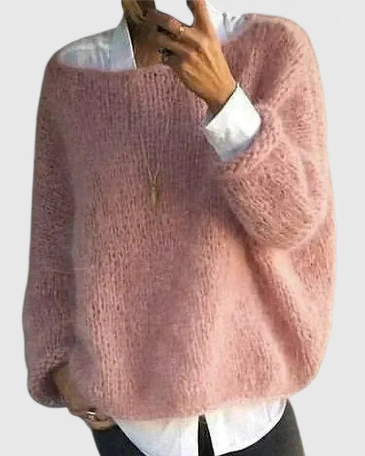 Close-up of a pink fluffy knit jumper with dropped shoulders, worn open over a white button-down shirt