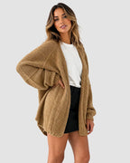 Side view of the camel oversized cardigan showing the ribbed cuff and open-front drape