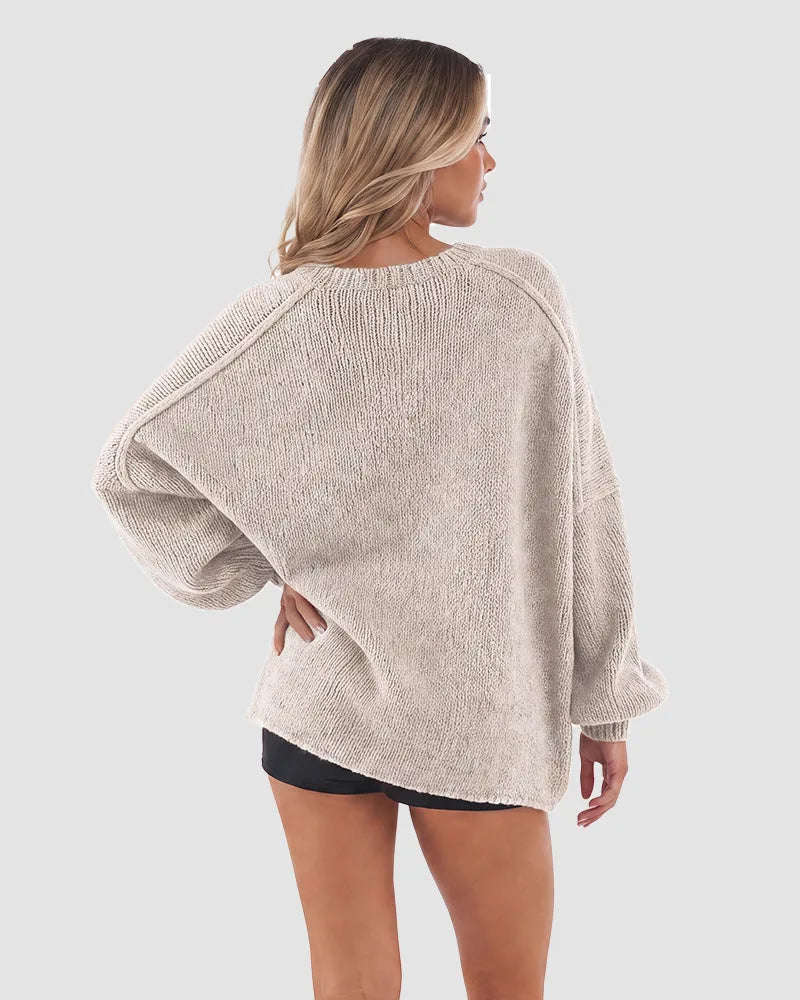 Back view of the light beige cardigan showing the ribbed knit texture and loose fit