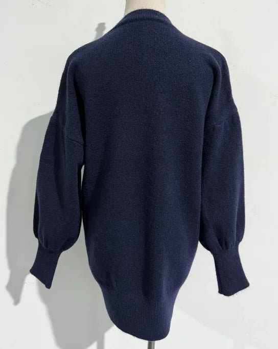 Back view of the navy knit jumper showing the ribbed hem, cuffs and relaxed oversized silhouette