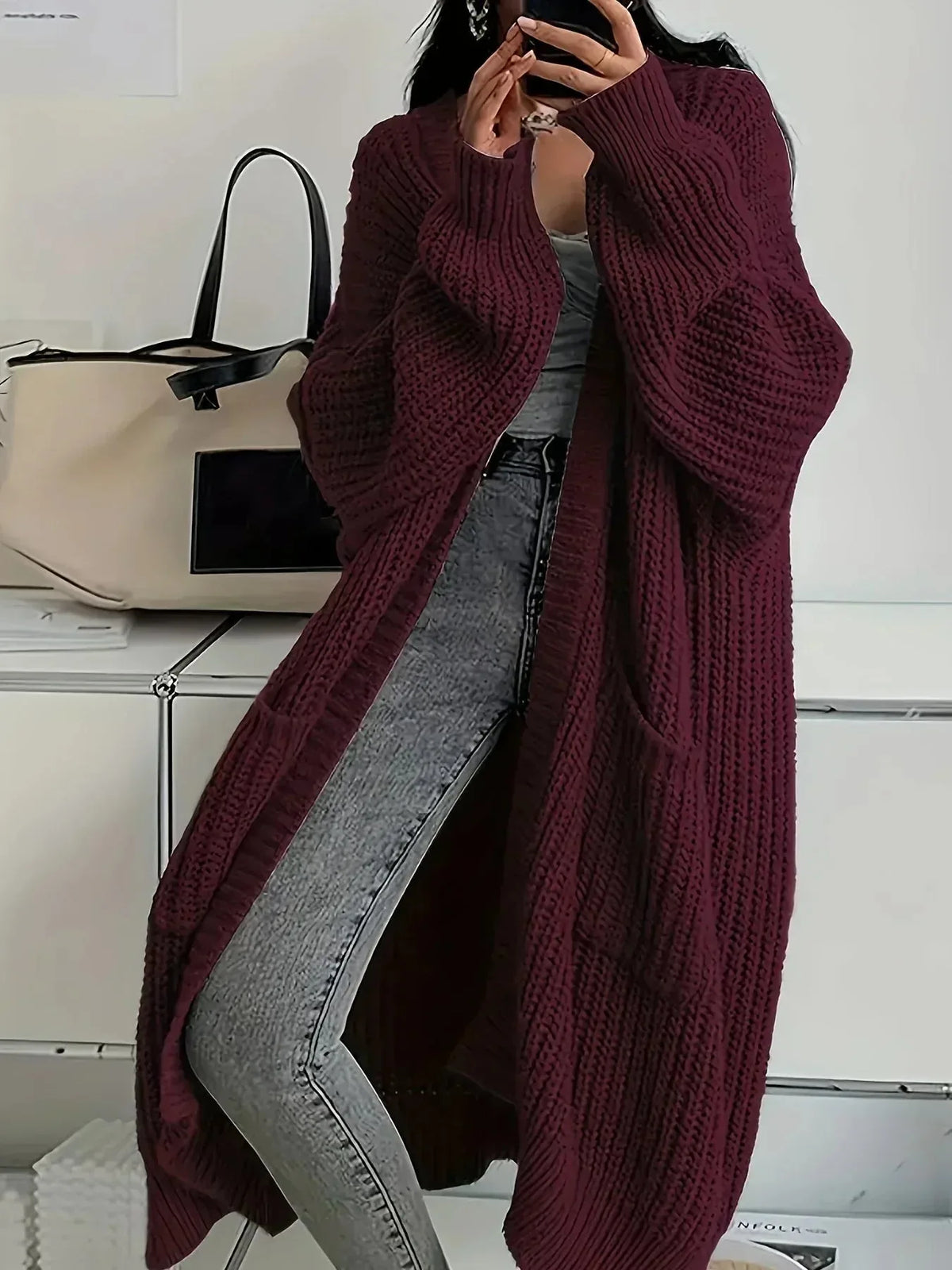 Burgundy long oversized knit cardigan with ribbed texture, dropped shoulders and roomy pockets