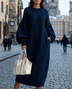 Model wearing a navy blue ribbed knit oversized maxi jumper dress with balloon sleeves near Old Town Square
