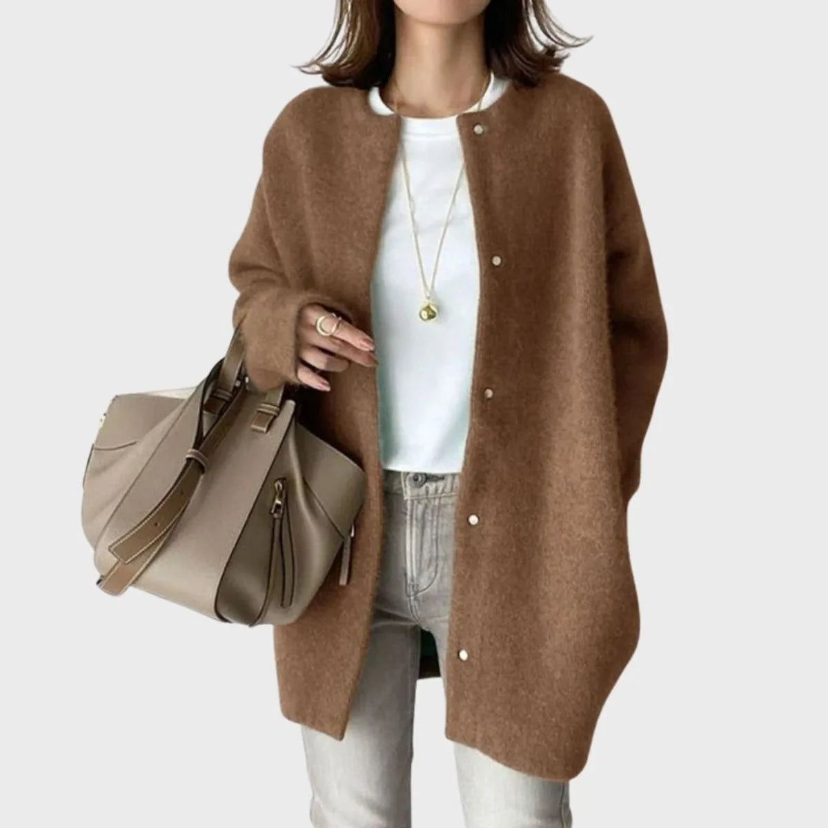 Model wearing a brown oversized cardigan with round neckline and dropped shoulders, snap buttons fastened down the front