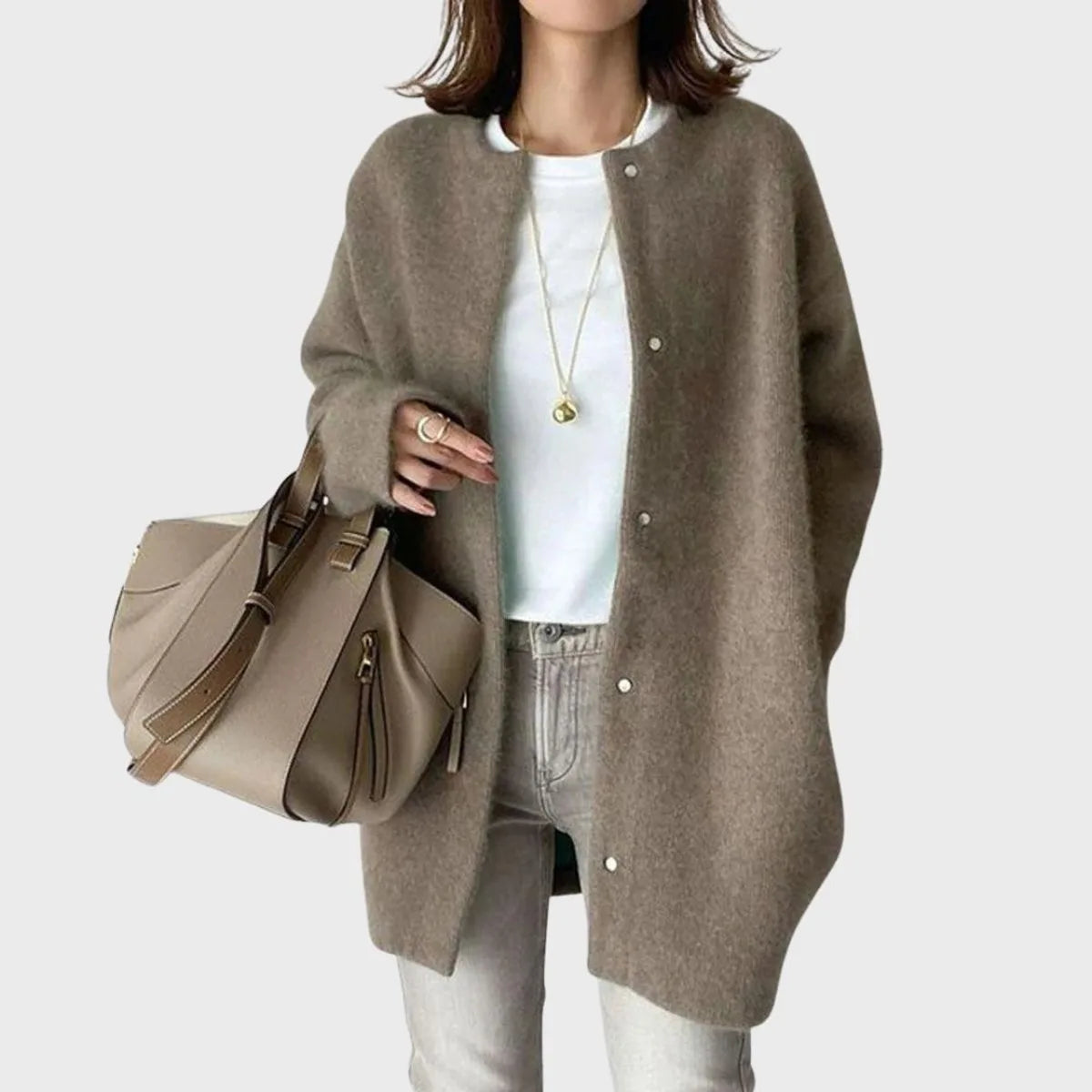 Coffee brown oversized cardigan with long sleeves, worn unfastened over light wash denim jeans
