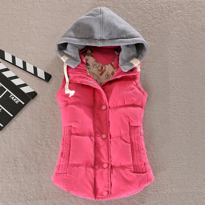 Fuchsia pink padded gilet with grey jersey hood, front snap buttons and side pockets, laid flat