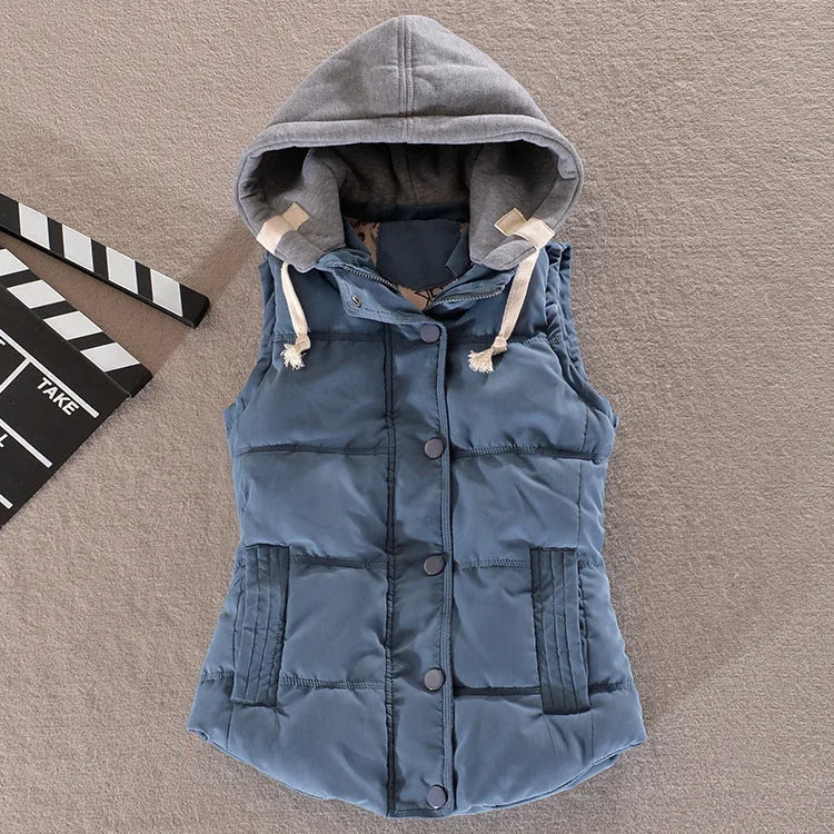 Granite blue padded gilet with grey hood and drawstrings, shown buttoned up on a flat surface