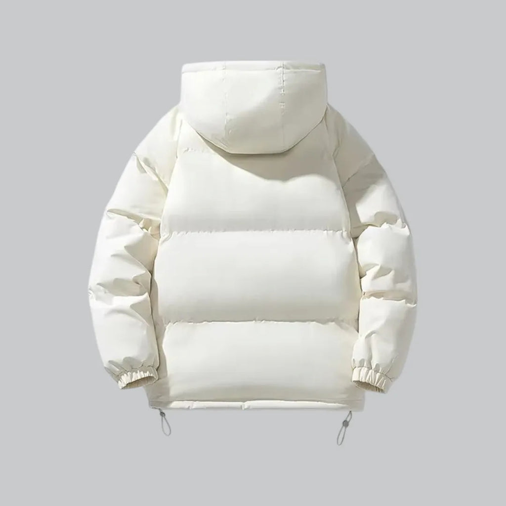 Back view of cream white quilted hooded jacket with horizontal panel seams and hood detail