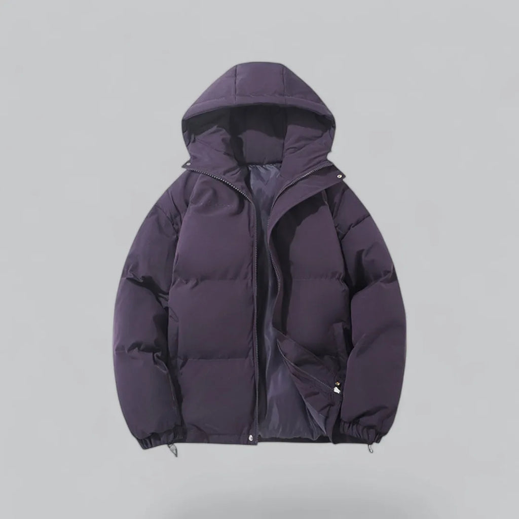 Close front view of a quilted hooded jacket highlighting the chunky zip and side pockets