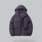 Close front view of a quilted hooded jacket highlighting the chunky zip and side pockets