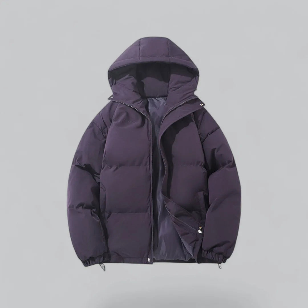Close front view of a quilted hooded jacket highlighting the chunky zip and side pockets