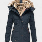 Navy blue quilted winter jacket with brown faux fur hood lining and ribbed cuffs, front detail view