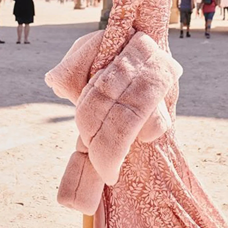 Detail shot of the quilted puffer sleeve and ribbed cuff texture on the pink faux fur jacket