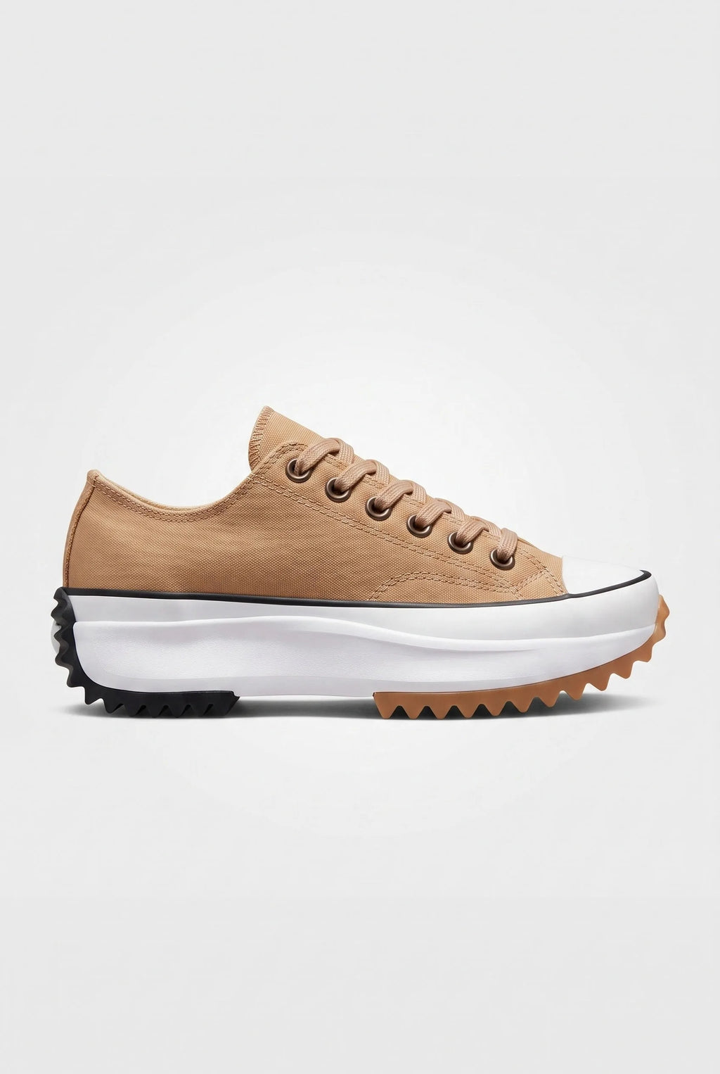 Side view of sandstone beige canvas platform trainer with lace-up front and chunky black and gum serrated sole