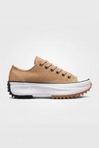 Side view of sandstone beige canvas platform trainer with lace-up front and chunky black and gum serrated sole