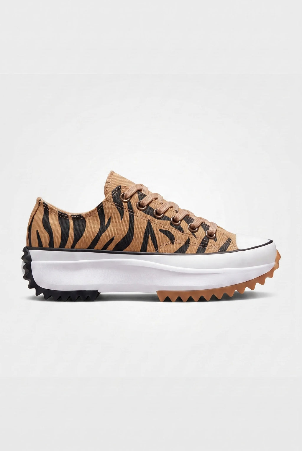Side view of tiger stripe print canvas platform trainer with tan laces and serrated black and gum outsole