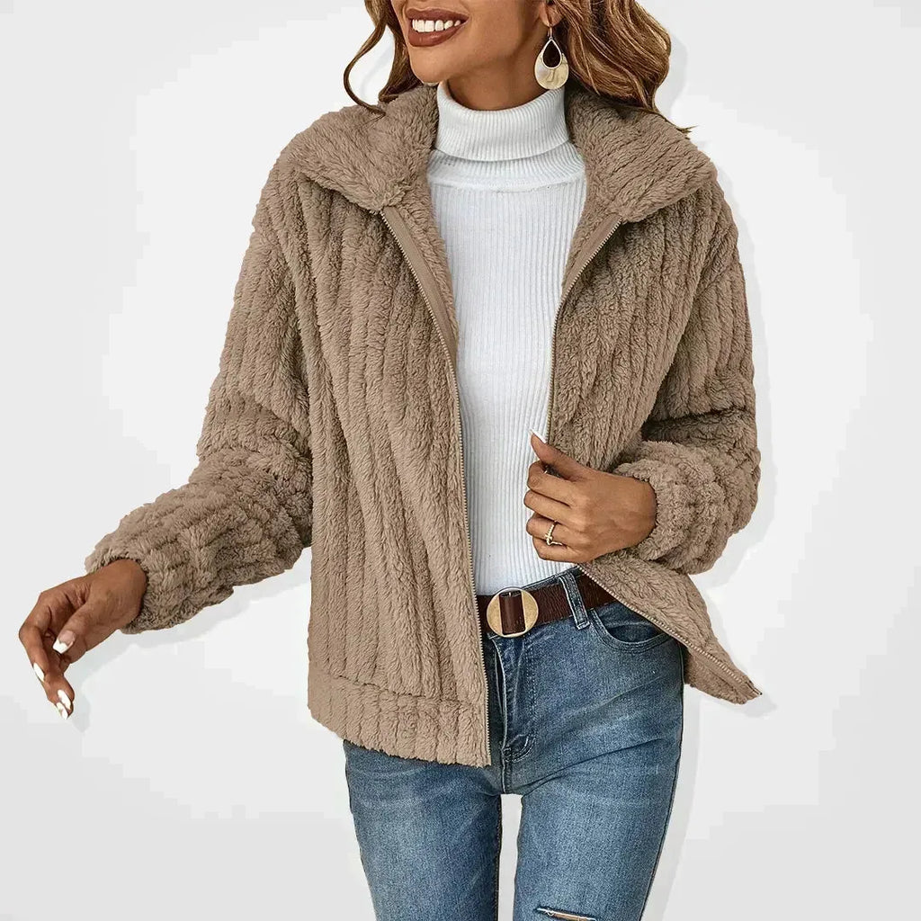Khaki plush textured cardigan worn open over a white polo neck jumper, showing the wide collar and front zip