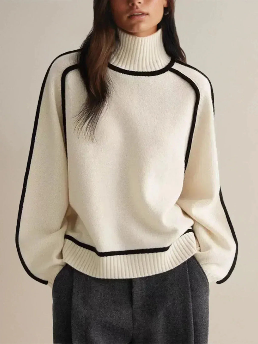 Front view of cream ribbed turtleneck jumper showing black piped seams and dropped shoulder cut
