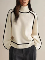 Front view of cream ribbed turtleneck jumper showing black piped seams and dropped shoulder cut