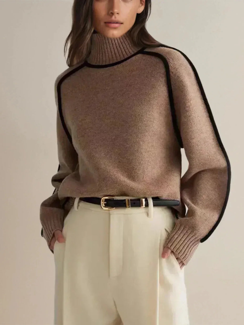 Cropped view of oatmeal polo neck jumper with visible ribbed cuffs and contrast piping down the arm