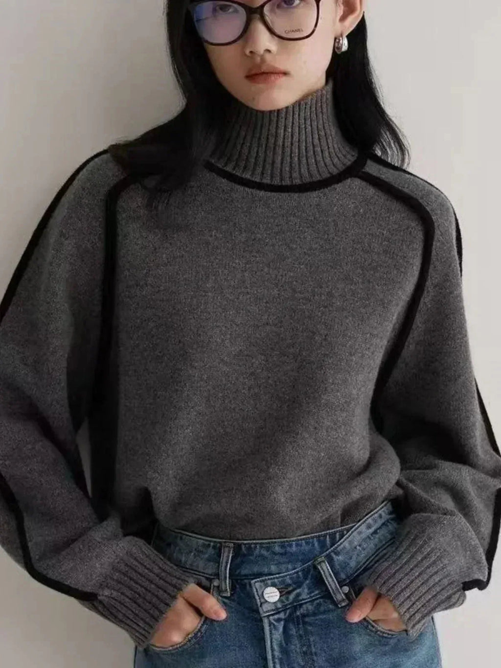 Front detail of dark grey ribbed knit jumper showing contrast trim and relaxed oversized fit