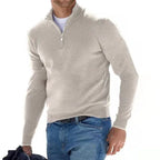 Close angle of an oatmeal beige quarter-zip jumper highlighting the soft knit texture and ribbed hem.