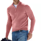 Man wearing a dusty pink quarter-zip jumper with the zip partly open, showing the layered t-shirt underneath.