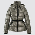 Front view of metallic gunmetal puffer jacket with high collar, belted waist and detachable hood