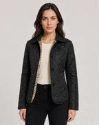 Black quilted jacket worn open over a cream top, showing checked fabric lining at the front placket