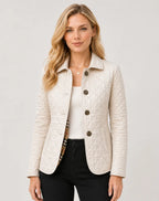 Cream quilted jacket with button fastening and checked lining peeking from the collar and pockets