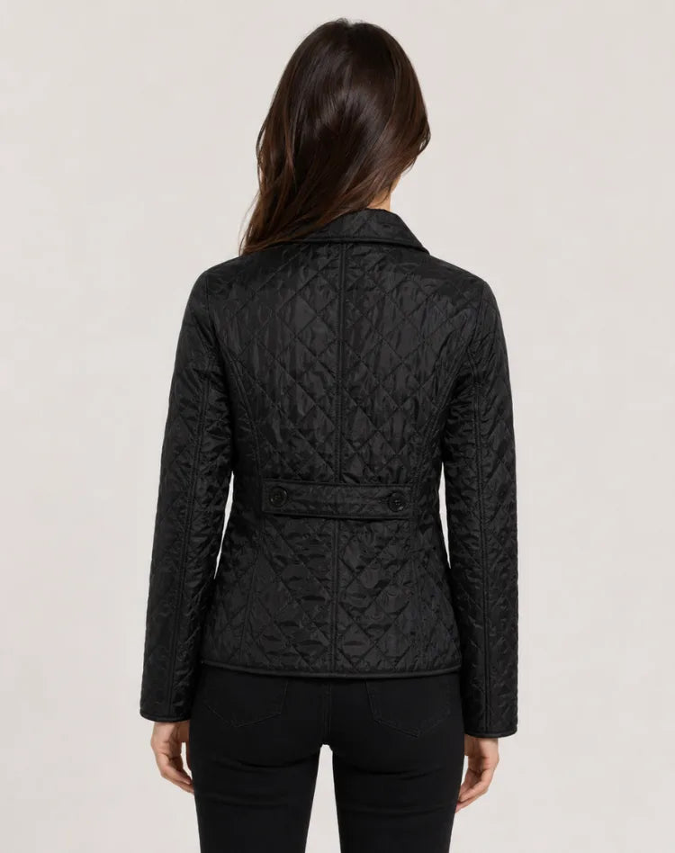 Back view of black quilted jacket showing waist tab detail and diamond-quilted panels