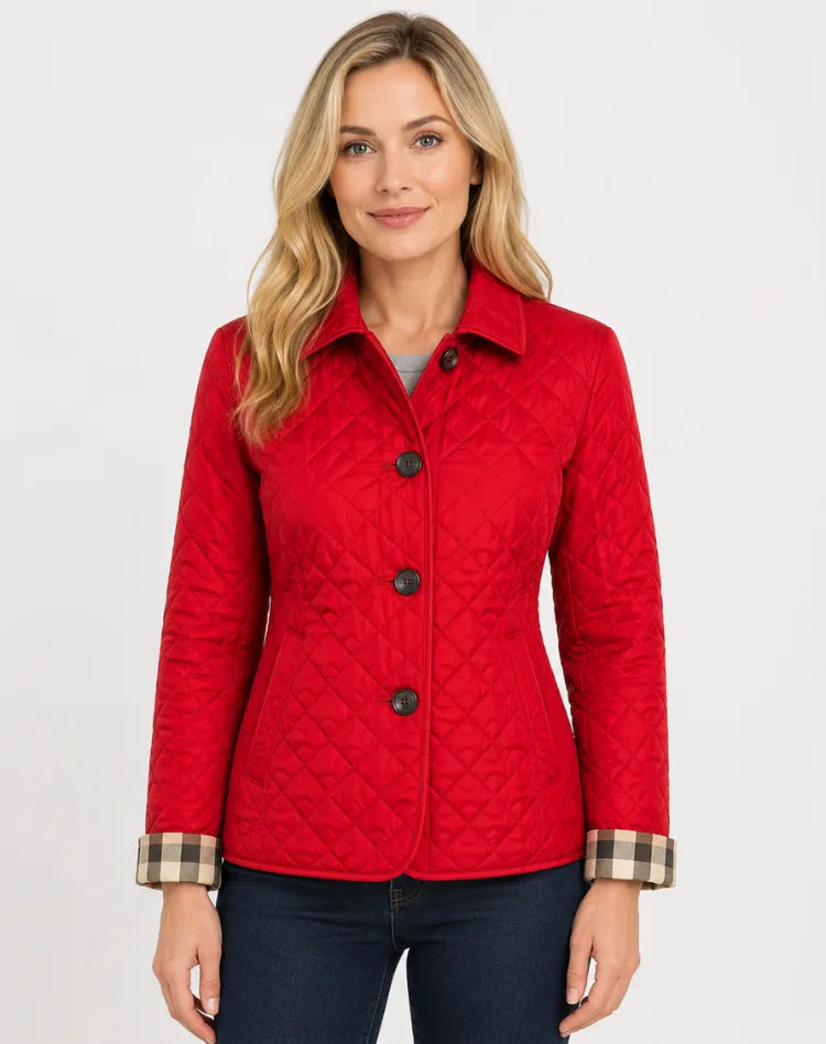 Red quilted jacket with buttoned collar and checked cuffs, worn with dark denim