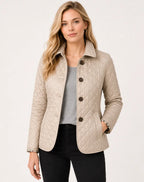 Beige quilted jacket with checked lining visible at cuffs and pockets, worn with grey top