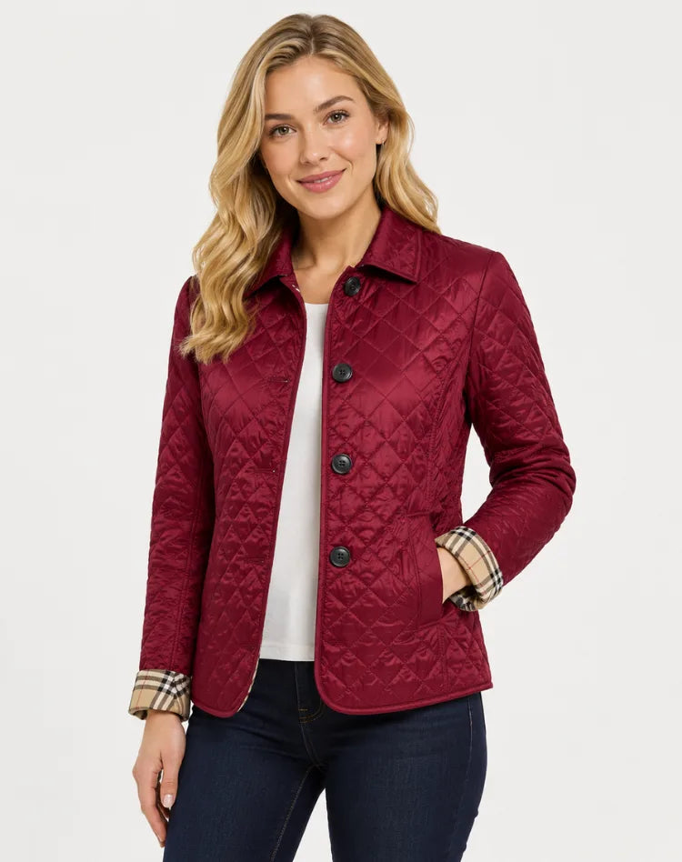 Burgundy quilted jacket with button fastening and checked lining showing at the cuffs