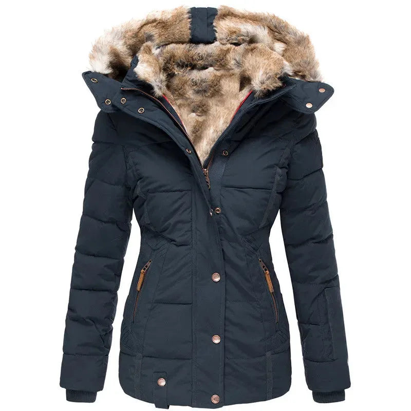Front view of navy quilted parka with large faux fur trimmed hood open, showing tan fur lining and bronze zip