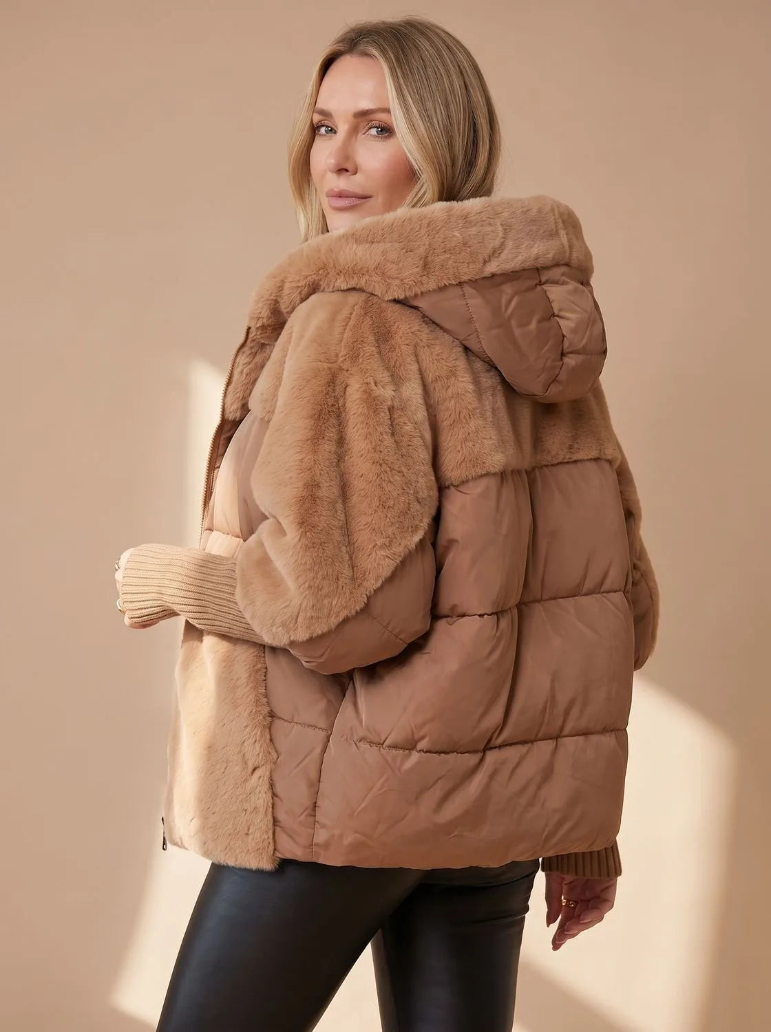 Side back view of brown faux fur puffer jacket highlighting plush hood, quilted body and ribbed cuff