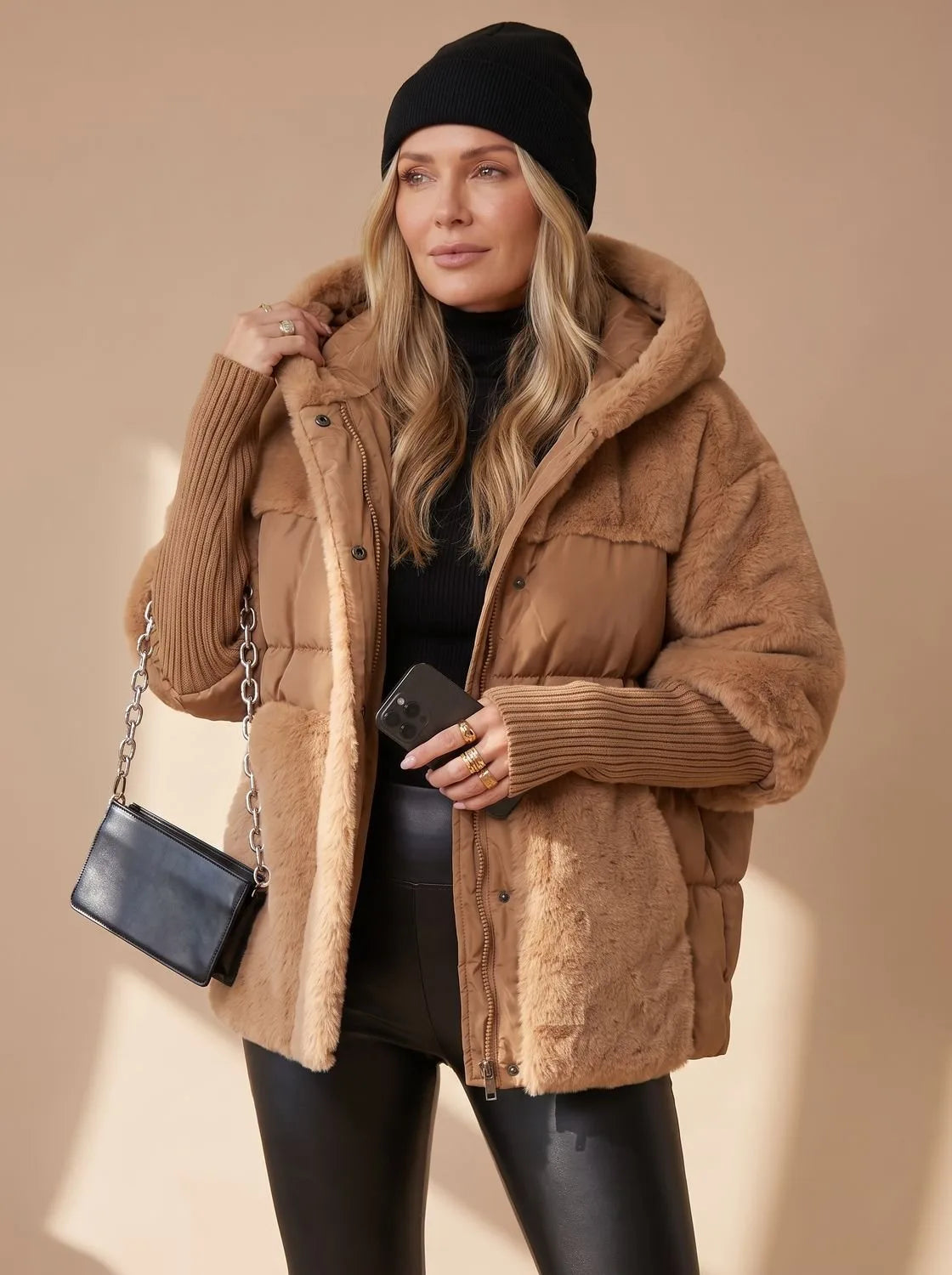 Close-up front view of grey faux fur puffer jacket worn with sunglasses, holding a coffee cup
