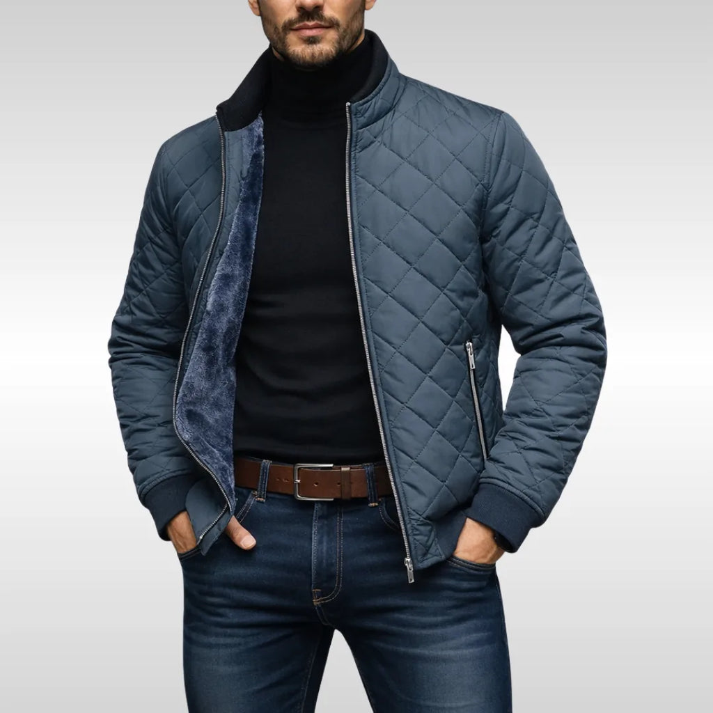 Front view of the steel-blue quilted jacket worn open, showing the stand collar and zip-up chest pocket
