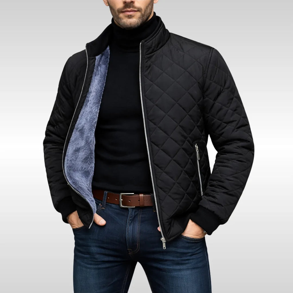 Black quilted jacket worn open over a black polo neck, showing the diamond stitch pattern and zip pocket detail