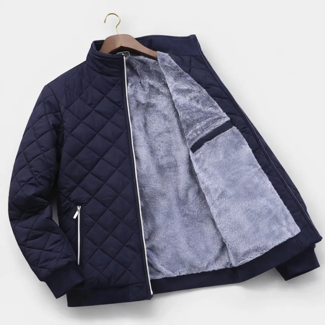 Navy quilted jacket laid flat on a wooden hanger, showing the full grey fleece lining and inner zip pocket