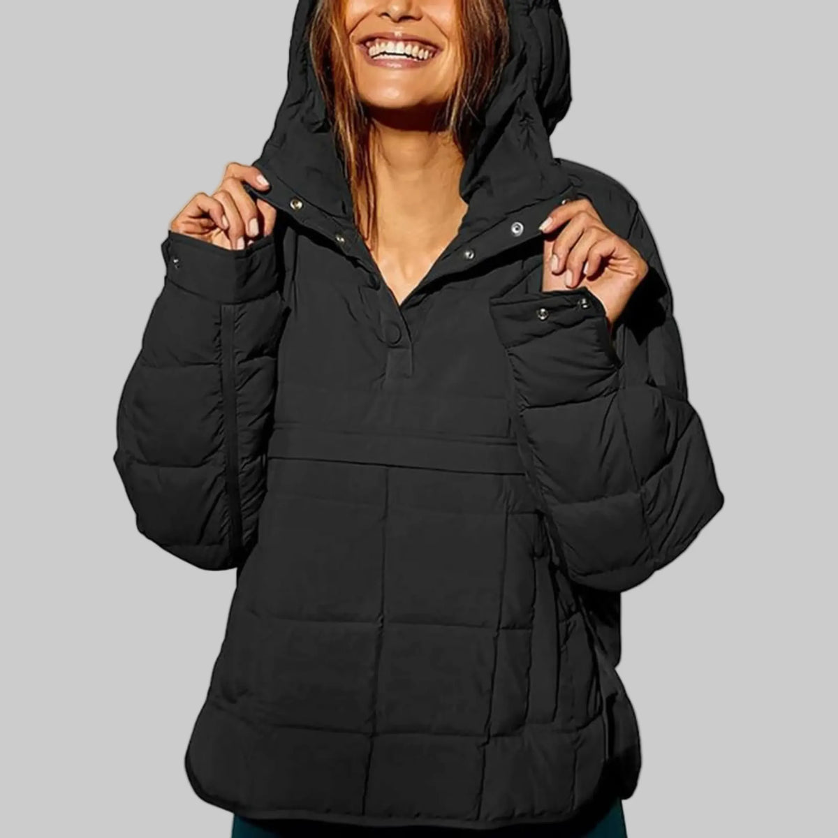 Black quilted hooded pullover jacket with hood up, close view of snap-button placket detail