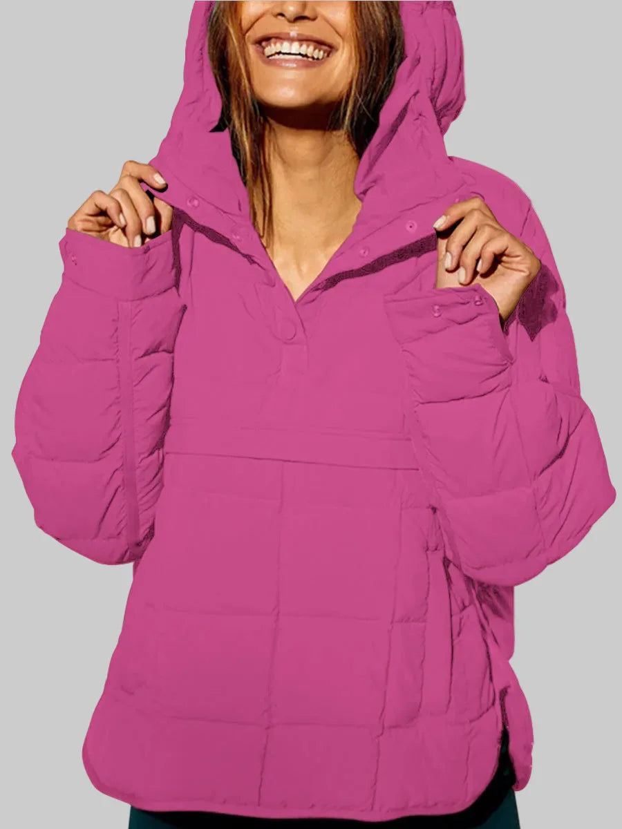Bright pink quilted anorak with hood pulled up and collar tabs fastened with snap buttons