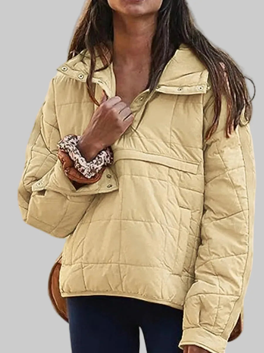 Yellow quilted anorak jacket worn open over navy leggings, front kangaroo pocket visible