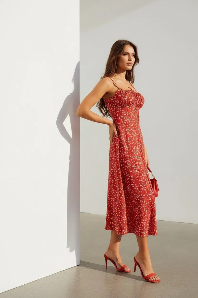 Close side view highlighting the fine straps, ruched bust detail and delicate floral print on red fabric