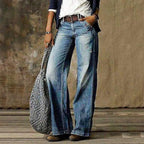 Front view of light blue faded wide-leg denim jeans styled with a brown leather belt and navy jacket