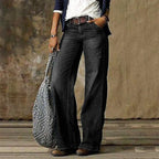 Dark charcoal black wash wide-leg jeans paired with a brown belt and ankle boots