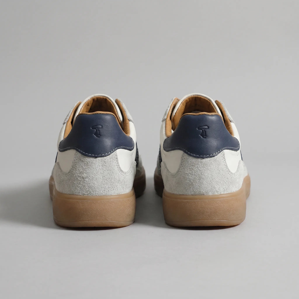 Back view of both trainers showing navy heel tabs with embossed logo and grey suede heel counters