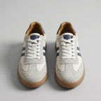 Front-on view of both trainers highlighting the crossed white laces and navy tongue trim