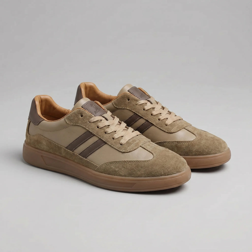 Side profile of a pair of taupe brown trainers with darker brown stripes and suede detailing