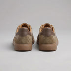 Back view of brown trainers showing the dark brown heel tabs and tan leather inner lining
